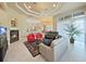Open living space with fireplace, tile flooring, ceiling fan, and access to the kitchen at 11213 Warm Wind Way, Weeki Wachee, FL 34613