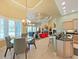 Open living space with eat-in kitchen featuring natural light, modern light fixtures, and neutral color palette at 11213 Warm Wind Way, Weeki Wachee, FL 34613
