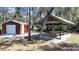 Outdoor area featuring a storage shed and a covered picnic shelter with a concrete table at 11213 Warm Wind Way, Weeki Wachee, FL 34613