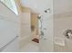Detail of shower with multiple shower heads, bench, and accessible grab bars at 11213 Warm Wind Way, Weeki Wachee, FL 34613