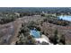 Aerial view of private tennis court surrounded by trees and landscaping at 11213 Warm Wind Way, Weeki Wachee, FL 34613