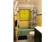 Retro bathroom with yellow tile and mint tub at 11523 Forest Hills Dr, Tampa, FL 33612