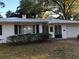 Mid-century modern home with white exterior at 11523 Forest Hills Dr, Tampa, FL 33612