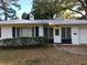 Mid-century modern home with white exterior at 11523 Forest Hills Dr, Tampa, FL 33612