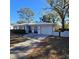 Mid-century modern home with white exterior at 11523 Forest Hills Dr, Tampa, FL 33612