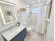 Updated bathroom featuring a walk-in shower, marble countertops, and modern fixtures at 6075 Shore S Blvd # 306, Gulfport, FL 33707