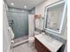 Updated bathroom includes a modern vanity, lighted mirror, and tiled walk-in shower at 6075 Shore S Blvd # 306, Gulfport, FL 33707