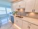 Kitchen counter featuring stainless dishwasher and sink with a view of the water at 6075 Shore S Blvd # 306, Gulfport, FL 33707