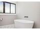 Relaxing bathroom with freestanding tub and hexagon tile flooring at 3508 N Dartmouth Ave, Tampa, FL 33603
