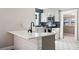 Modern kitchen with white cabinets, hex tile floor and quartz countertops at 3508 N Dartmouth Ave, Tampa, FL 33603