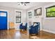 Bright living room features hardwood floors, fireplace, and comfy armchairs at 3508 N Dartmouth Ave, Tampa, FL 33603