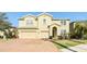 Two-story house with a three-car garage and landscaped front yard at 11544 Lake Lucaya Dr, Riverview, FL 33579