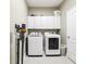 Laundry room with washer, dryer, and ample cabinet storage at 11544 Lake Lucaya Dr, Riverview, FL 33579