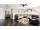 Upstairs living area with dark hardwood floors and ceiling fan at 11544 Lake Lucaya Dr, Riverview, FL 33579