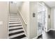 Modern staircase with black and white risers leading to the second floor at 11544 Lake Lucaya Dr, Riverview, FL 33579