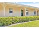 Front view of a condo unit with a neatly trimmed hedge at 2465 Northside Dr # 205, Clearwater, FL 33761