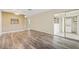 Living room with wood-look floors, access to laundry and patio at 2465 Northside Dr # 205, Clearwater, FL 33761