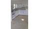 White kitchen with ample cabinet space and terrazzo floors at 5593 40Th N Ave # 319, St Petersburg, FL 33709