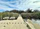 Community dock with benches overlooking a tranquil waterway at 8333 Hardy Bay Loop, Wesley Chapel, FL 33545