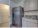 Stainless steel refrigerator and pantry with wire shelving at 8333 Hardy Bay Loop, Wesley Chapel, FL 33545