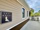 Lake house exterior with deck and signage at 8333 Hardy Bay Loop, Wesley Chapel, FL 33545