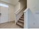 Modern staircase with neutral carpeting and tile flooring at 8333 Hardy Bay Loop, Wesley Chapel, FL 33545