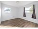 Bright bedroom with wood-look floors, white walls, and natural light from two windows at 3637 63Rd N St, St Petersburg, FL 33710