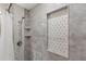 A shower with geometric tiles, marble tile, and a shower head at 3637 63Rd N St, St Petersburg, FL 33710