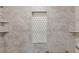 Shower with geometric tiles, marble tile, ledges, and a shower head at 3637 63Rd N St, St Petersburg, FL 33710