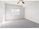 Sunlit bedroom featuring a large window and ceiling fan at 501 Knights Run Ave # 1217, Tampa, FL 33602