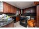 Dark wood cabinets, granite countertops, and appliances at 635 Hudson Ave, Tampa, FL 33606