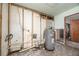 Kitchen under renovation with exposed pipes and water heater at 635 Hudson Ave, Tampa, FL 33606