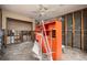 Unfinished room with orange shelving unit and exposed walls at 635 Hudson Ave, Tampa, FL 33606