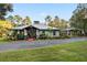 Craftsman style home with covered porch and landscaped yard at 8356 Owls Roost Ln, Brooksville, FL 34601