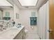 Bathroom with gray vanity and patterned tile floor at 11200 102Nd N Ave # 66, Seminole, FL 33778