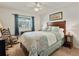 Bedroom with leafy comforter and wooden furniture at 11200 102Nd N Ave # 66, Seminole, FL 33778