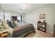 Main bedroom with a king-size bed, built-in shelving, and natural light at 11200 102Nd N Ave # 66, Seminole, FL 33778