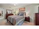 Bright bedroom with striped comforter and wood furniture at 11200 102Nd N Ave # 66, Seminole, FL 33778