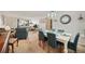 Inviting dining room with a white table and blue chairs, seamlessly connecting to the comfortable living space at 11200 102Nd N Ave # 66, Seminole, FL 33778