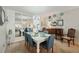 Dining room featuring a white table, blue chairs, and mirror at 11200 102Nd N Ave # 66, Seminole, FL 33778