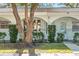 Close-up highlighting the condo's archway details, manicured landscaping, and inviting front entrance at 11200 102Nd N Ave # 66, Seminole, FL 33778