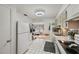 White cabinets, stainless steel appliances, and an open floor plan are featured in this kitchen at 11200 102Nd N Ave # 66, Seminole, FL 33778