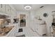 This galley kitchen boasts white cabinets and stainless steel appliances at 11200 102Nd N Ave # 66, Seminole, FL 33778