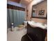 Clean bathroom, shower/tub combo, dark vanity at 855 Pinewood W Ter, Palm Harbor, FL 34683
