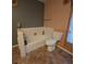 Bathroom featuring a bathtub, toilet, and tiled flooring at 855 Pinewood W Ter, Palm Harbor, FL 34683