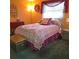Cozy bedroom with a double bed and colorful bedding at 855 Pinewood W Ter, Palm Harbor, FL 34683