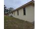 Exterior side view of house showcasing architectural details and landscaping at 855 Pinewood W Ter, Palm Harbor, FL 34683