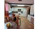 Kitchen features white cabinets, tile floor and breakfast nook at 855 Pinewood W Ter, Palm Harbor, FL 34683