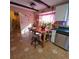 Kitchen with island, white cabinets, and tile floor at 855 Pinewood W Ter, Palm Harbor, FL 34683