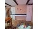 Kitchen with white cabinets, tile floor and built-in desk area at 855 Pinewood W Ter, Palm Harbor, FL 34683